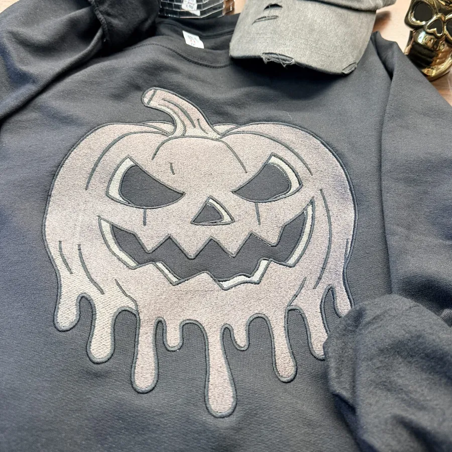 Close-up of metallic thread detail on sweatshirt embroidery